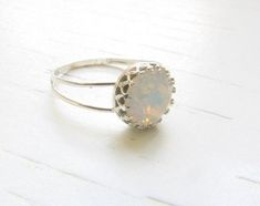 White opal ring - sterling silver 925Silver ring, vintage style with beautiful white opal swarovski crystal (8mm.) Click here for more ringshttps://www.etsy.com/il-en/shop/MoonliDesigns?ref=hdr_shop_menu&section_id=21288938♥♥♥♥♥♥♥♥♥♥♥♥► Nickel Free ✔► Tarnish Resistant ✔► No Allergic reaction ✔► 30 days return policy ✔ ► Accept replacements and custom orders ✔♥♥♥♥♥♥♥♥♥♥♥♥► I ship all items in a jewelry gift box ✔► Greeting card - upon request ✔ ♥♥♥♥♥♥♥♥♥♥♥♥Shipping information :► Tracking nu Peridot Ring Gold, Opal Ring Silver, Sterling Silver Opal Ring, Jewelry Opal, Silver Opal Ring, White Opal Ring, Opal Band, Nature Inspired Rings, Opal Ring Gold