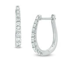 Take your dressy looks to the next level with these dazzling certified diamond hoop earrings. Created in 14K white gold, each 17.0 x 12.0mm oval-shaped hoop features a row of sparkling graduated-size diamonds - the largest being 1/20 ct. stones. Each diamond boasts a color rank of H and a clarity of I1. Radiant with 1/2 ct. t.w. of diamonds and a bright polished shine, these earrings secure with hinged backs. This style arrives with a certificate that includes a photo and description of the diam Oval Diamond Hoop Earrings In White Gold, Oval Diamond White Hoop Earrings Fine Jewelry, White Gold Diamond Hoop Earrings With Oval Shape, Diamond White Oval Hoop Earrings With Prong Setting, White Gold Oval Diamond Hoop Earrings, Oval Diamond Hoop Earrings With Diamond Accents, Timeless Oval White Gold Hoop Earrings, Oval Diamond Hoop Earrings With Accents, Oval Brilliant Cut Hoop Earrings For Formal Events