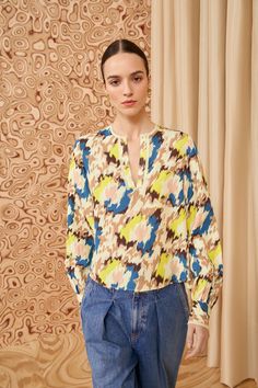 Tailored from textured satin-back crepe, our Greta Blouse features abstract floral ikat motifs that pulse with shades of yellow, cream, and blue. This top has long sleeves that billow slightly, buttoned cuffs, and a notched neckline with a relaxed fit. It’s the perfect companion to our seasonal denim and tailoring. Composition: 100% Viscose Pair with our Willow Jean and Mini Floret Stud Earring to complete the look. Ikat Motifs, Nyc Boutiques, Notched Neckline, Yellow Cream, Yellow Print, Knit Sweatshirt, Signature Print, Shades Of Yellow, Event Dresses