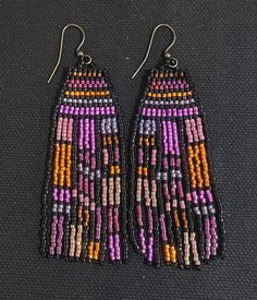 Beautiful fuchsia, purple and gold combine in this unique pattern. Also available in blue and assorted bright colors under separate listings. Purple Festival Jewelry With Ear Wire, Purple Drop Earrings For Festival, Unique Purple Earrings With Ear Wire, Artisan Purple Beaded Dangle Earrings, Vibrant Multicolor Beaded Earrings As Gift, Purple Beaded Dangle Earrings For Festival, Purple Dangle Beaded Earrings For Festival, Bohemian Purple Festival Earrings, Unique Multicolor Festive Earrings