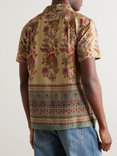 Kardo employs heritage weaving, dyeing and printing techniques so every item of clothing is a true celebration of craftsmanship. This 'Chintan' shirt is made from cotton that's patterned with ornate florals and a wallpaper-like border. The label uses only natural pigments throughout its collections. Responsible Craftsmanship. This product promotes artisanal skill and brands that invest in communities and adhere to fair-trade principles. Find out more about our Consciously Crafted criteria here. Traditional Brown Festive Tops, Festive Brown Traditional Tops, Festive Traditional Brown Tops, Relaxed Fit Cotton Tops With Batik Print, Traditional Brown Summer Tops, Festive Cotton Short Sleeve Shirt, Traditional Relaxed Fit Cotton Shirt, Traditional Printed Shirt For Festivals, Traditional Cotton Shirt For Festivals