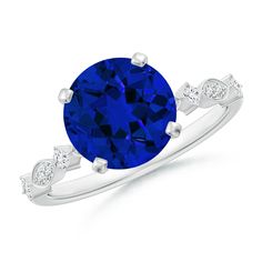 a blue sapphire and diamond ring with white diamonds on the band, set in 18k white gold