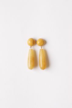 Ceramic dome stud with dangling gemstone teardrop bead. Approx. 2"L x 1/2"W Handmade Yellow Drop Jewelry, Yellow Handmade Drop Jewelry, Yellow Teardrop Earrings, Yellow Teardrop Earrings With Dangling Beads, Yellow Drop Jewelry With Matching Earrings, Gem Drop Earrings, Four Eyes, Teardrop Beads, Jade