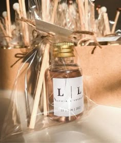 a jar filled with lots of brown stuff on top of a white table next to wooden sticks