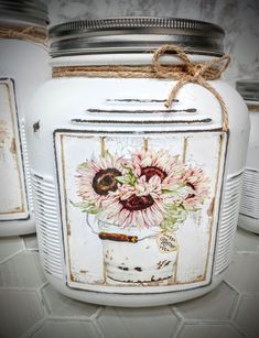 three white jars with flowers painted on them