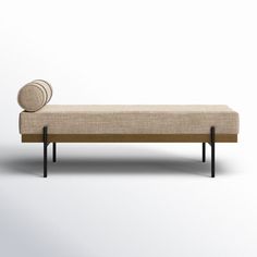 an upholstered bench with a round cushion on it