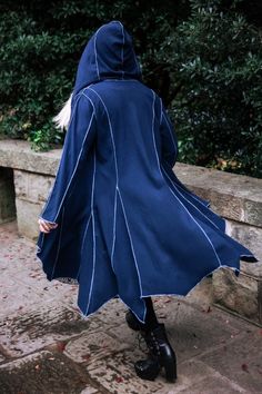 a woman wearing a blue coat and black boots