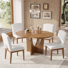 a dining room table with white chairs around it