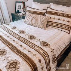 a bed with white and brown bedspread in a bedroom