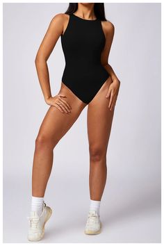 a woman in a black bodysuit posing for the camera