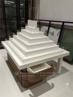 a white table sitting on top of a tiled floor