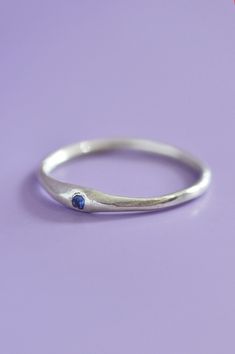 The Siyum gem ring is a true minimalist piece, a fine seamless round band is hand brushed finished allowing a contemporary aesthetic. Perfect for everyday, once you take it off you won't take it off! A petite round blue Sapphire adds a beautiful detail and personalised touch. Use the drop down to select your ring size.If you are unsure of your ring size refer to our size guide. Please select your ring size carefully, and reach out if you have any questions. DetailsSterling Silver Handcrafted in Blue Minimalist Promise Ring, Minimalist Blue Promise Rings, Minimalist Sapphire Ring With Bezel Setting For Everyday, Minimalist Blue Sapphire Ring For Everyday, Modern Sterling Silver Birthstone Ring For Everyday, Minimalist Everyday Blue Sapphire Ring, Modern Sapphire Ring With Round Band, Minimalist Sapphire Ring With Round Band For Promise, Blue Minimalist Sterling Silver Stackable Rings