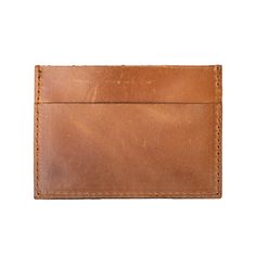 Description: Just need the basics? Easily carry your cards and cash in your front or back pocket with our leather card wallet for men and women. With three sleek pockets for your cards and cash, this unisex style is perfect for those who'd rather stick to carrying the basics. 3 7/8" Wide, 2 6/8" Tall Three slots for cards and cash Full-grain, vegetable dyed leather Comes in four colors, brown, camel, black and maroon Handcrafted by artisans in India Each piece is handcrafted with 100% full-grain Wallet For Men, Leather Card Wallet, Leather Card Holder, Pencil Bags, Leather Conditioner, Tote Bag Leather, Fold Wallet, Card Holder Leather, Leather Care