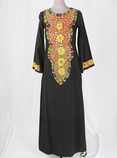 Long sleeved black linen maxi dress with embroidered flower design down front and on sleevesEmbroidered design of yellow, green blue and redSmall circular mirrors sewn into embroidered designZips up the back and secures with hook at necklineSlit at left hem of skirt3/4 sleevesLabel reads made in Pakistan, 100% cotton, MBust = 35"Hips + 36"Length = 21"Sleeve = 55" Multicolor Embroidered Fitted Maxi Dress, Spring Festive Embroidered Maxi Dress, Traditional Long Sleeve Maxi Dress With Multicolor Embroidery, Festive Embroidered Cotton Maxi Dress, Traditional Cotton Dress With Embroidered Sleeves, Embroidered Cotton Floor-length Dress, Multicolor Floral Embroidery Maxi Dress With Long Sleeves, Long Sleeve Multicolor Maxi Dress With Floral Embroidery, Multicolor Long Sleeve Maxi Dress With Floral Embroidery