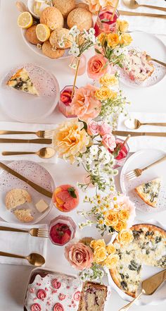 a table topped with lots of food and plates filled with different types of pies