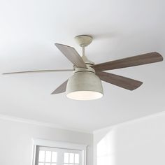 a ceiling fan in a room with white walls