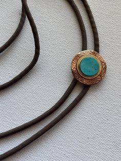 Natural Turquoise coin cab stone on a vintage red brass setting and brown nylon cord. Mens Turquoise Jewelry, Bolo Ties For Men, Bolo Tie Necklace, Vintage Setting, Cabo Wedding, Desert Elopement, Tie Necklace, Bolo Ties, Metal Stars