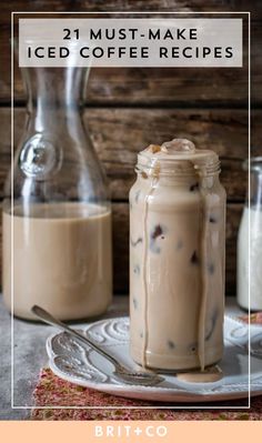 two jars filled with iced coffee sitting on top of a table