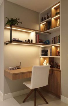 a desk and chair in a room with bookshelves