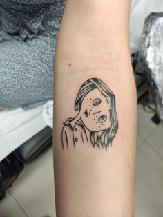 a woman's arm with a black and white drawing of her face on it