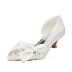 a white shoe with a bow on the heel