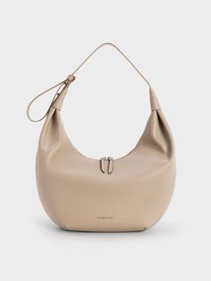 This product is made with at least 20% sustainable materials by weight. CHARLES & KEITH uses recycled, degradable, organic, and water-based materials in our eco-conscious collection. For the minimalist girls, the Odella hobo bag is the perfect everyday carrier. Its sleek crescent shape lets clean curves and the polished taupe finish stand out, making it a stylish accessory that is as chic as it is versatile. For a relaxed feel, tasteful ruching gives the carrier a slouchy look that will pair well with off-duty ensembles. Complete with a roomy interior, you will want to reach for the Odella over and over again. Crescent Shape, Size Chart For Kids, Charts For Kids, Vegan Leather Bag, Charles Keith, Printables Kids, Everyday Bag, Sustainable Materials, Online Bags