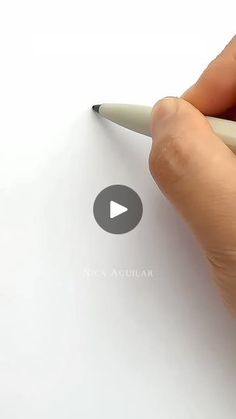 a person is writing on a piece of paper with a pen in their left hand