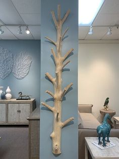 a sculpture of a tree is on the wall in an office setting with blue walls