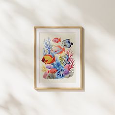 a painting hanging on the wall next to a white wall with a fish and corals