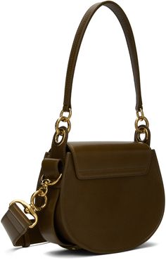 LWG-certified grained calfskin and suede shoulder bag in khaki. · Detachable shoulder strap · Adjustable and detachable crossbody strap · Logo-engraved O-ring at face · Logo embossed at face · Concealed patch pocket · Magnetic press-stud flap · Card slot at interior · Canvas lining · Gold-tone hardware · H7 x W8 x D3 Supplier color: Dark khaki Olive Leather Shoulder Bag With Detachable Strap, Luxury Olive Bag With Detachable Strap, Luxury Olive Leather Shoulder Bag, Chloe Tess, Face Logo, Dark Khaki, Chloe Bag, Press Studs, Free Bag