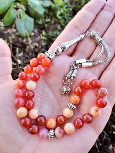 ✔️ This magnificent red Agate tasbih made with high grade 8 mm Genuine fire agate stone beads. ✔️ It is a elegant and striking Natural aqiq tesbih. ✔️ Natural Color hakik tasbeeh ✔️ Natural Aqeeq Stone ✔️ Each order comes in a special box. ✔️ PLEASE CLICK THE LINK FOR ALL PRAYER BEADS MODELS https://www.etsy.com/shop/GoodJewelsofYazmasal Note: As a natural feature the stones beads may have some variations. SHIPPING: United States (Standart/DHL eCommerce/usps): 7-10 business days United States (E Natural Stone Round Beads For Festivals, Orange 8mm Beads For Jewelry Making, Red Gemstone Beads As Gift, Red Gemstone Beads For Gifts, Traditional Agate Beaded Bracelets Gift, Traditional Agate Beaded Bracelet Gift, Traditional Carnelian Beads For Gift, Traditional Agate Beads And Cabochons For Gifts, Traditional Carnelian Beads As A Gift