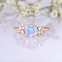 a ring with an opal stone surrounded by white flowers