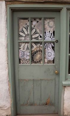 a green door with lace doily on it