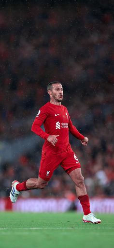 a soccer player is running on the field