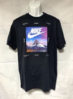 Nike Men's Sportswear Standard Issue Photo T-Shirt - M (Black) Standard fit Ribbed collar Nike Air logo set against the Matterhorn Mountainscape is framed by Nike graphic hits and "Just Do It" slogans Machine Wash Country of Origin: Imported Style: DX1087-010 Fabric: 100% cotton Brand: Nike Nike T Shirts Mens, Collar Nike, Masculine Shirts, Nike T Shirt Mens, Nike Air Logo, Nike T Shirts, Air Logo, The Matterhorn, Nike Design