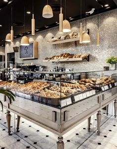 a bakery with lots of breads and pastries on display in the front counter