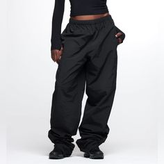 New With Tags Thirtyyears Black Track Pants. Size Small With 36” Inseam. Track-Style Pants Made Of 100% Nylon, Featuring An Interior Drawcord Toggle, Two Side Seam Pockets + One Cargo-Style Back Pocket And Elastic Zip Cuffs. 100% Nylon/100% Polyester Lining Elastic Waist With Interior Drawcord Toggle Elastic Zip Cuffs Two Side Seam Pockets, One Back Pocket Fabric Care: For Best Results, Machine Wash Cold And Hang Dry. Do Not Iron Or Dry Clean. Fit: True To Size. High Waist Nylon Sportswear Bottoms, High Waist Nylon Sports Pants, Sportswear High Waist Pants For Streetwear, Sportswear High-waist Pants For Streetwear, Straight Parachute Pants With Elastic Waistband For Streetwear, Black Full-length Sportswear Bottoms, High-waisted Nylon Bottoms With Side Pockets, Baggy Parachute Pants For Sports With Elastic Waistband, Baggy Parachute Pants With Elastic Waistband For Sports