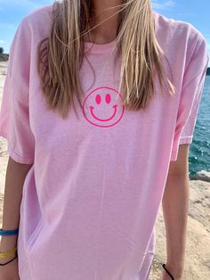 Smiley Face Tee! 👕 Hoodies or Sweatshirts are: -Classic fit (UNISEX) Slightly larger than women's sizing. -Eco smart 🌟 CARE INSTRUCTIONS 🌟 -Wash item inside out with cold/cold settings -Do not bleach - Do not dry clean 🚛 SHIPPING INFO - Processing time: 2-7 business days Made-To-Order. - US delivery time: 2-7 business days. Trendy Smiley Face Tops For Everyday, Oversized Pink Top For Fun, Cheap Pink Tops With Smiley Face, Spring Smiley Face Top For Streetwear, Casual Cotton Tops With Smiley Face, Summer Smiley Face Tops For Streetwear, Summer Streetwear Tops With Smiley Face, Fun Pink Tops With Smiley Face, Trendy Pink Smiley Face Tops