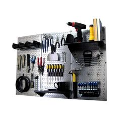 a pegboard with many tools hanging on it