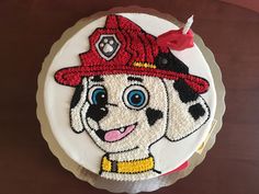 a birthday cake with a fireman dog on it