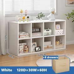 a white bookcase with four shelves in front of a window and a plant on the other side