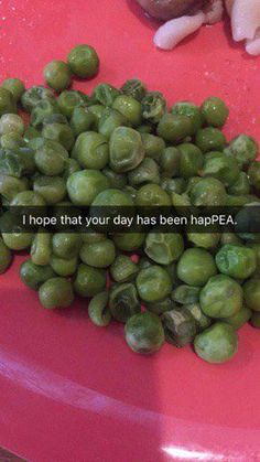 some green beans are on a red plate and one has the words i hope that your day has been happpea