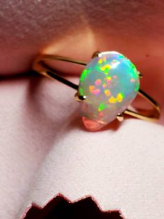 14k solid gold opal ring, beautiful opal with many bright rainbows adorning it mounted on a gold split shank ring. The ring is light and easy to wear and comes in 6 sizes I can swap the stone into. 14k Yellow Gold Opal Promise Ring, Yellow Gold Opal Ring In Fine Jewelry Style, Fine Jewelry Yellow Gold Opal Ring, Fine Jewelry 14k Gold Pear-shaped Opal Ring, 14k Gold Pear-shaped Opal Ring Fine Jewelry, 14k Gold Pear-shaped Opal Ring, Yellow Gold Opal Birthstone Ring, Pear-shaped 14k Gold Opal Ring Fine Jewelry, Pear-shaped 14k Gold Opal Ring