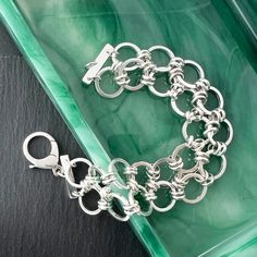 Handmade chain bracelet of heavy round links that are double connected. Sterling silver bracelet closes with a lobster clasp. These link chain bracelets fall gracefully around the wrist and hand in sterling silver. Link bracelets also make a great gift for a friend or family member. Size: Length is 7 1/2" and Width is 1". Weight 37.7 grams or 1.33 oz Bracelet Sizing: A good guide for your correct bracelet length is 1/2" longer than a tight wrist measurement. Use a flexible tape measure or strip of paper, then measure the paper strip with ruler. Composition: Handmade and one of a kind in nickel free sterling silver. Processing Time: Usually I can ship the item out within 2 days from the order date unless there is a back order. Back orders will be shipped within 2 weeks of the order date. SH Silver Link Bracelets With Rolo Chain, Silver Charm Bracelet With Rolo Chain Links, Silver Bracelet With Rolo Chain Oval Link, Silver Bracelet With Oval Link Rolo Chain, Elegant Chain Link Bracelets With Jump Ring, Elegant Link Bracelets With Jump Ring, Sterling Silver Rolo Chain Bracelet, Nickel-free Sterling Silver Chain Link Bracelet, Modern Silver Rolo Chain Bracelet