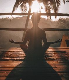 a woman sitting in the middle of a yoga pose