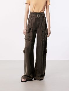 MO&Co. Women's Wide Leg Cargo Pants These pants are made from sustainable and eco-friendly materials, featuring a wide-leg and cargo style making them a fashionable and practical choice for a casual or streetwear look. The wide pocket design adds functionality and versatility, perfect for carrying essentials while on the go, and the belt ensures a secure fit and adds an extra touch of style. The brown pants may appear olive or khaki under different lighting. Features : - Wide leg in cargo style, Spring Utility Full Length Parachute Pants, Wide Leg Parachute Pants With Multiple Pockets For Work, Workwear Parachute Pants With Multiple Pockets, Baggy Utility Bottoms For Fall, Spring Wide Leg Cargo Pants, Baggy Utility Bottoms For Workwear, Wide Leg Bottoms With Flap Pockets For Spring, Fall Utility Baggy Bottoms, Workwear Bottoms With Multiple Pockets And Wide-leg Shape