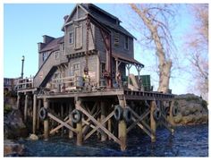 a wooden house sitting on top of a body of water