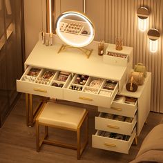 a white desk with drawers and a mirror on top of it next to a couch