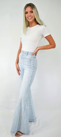 Feel-good retro stripes. An updated throwback, these jeans are cool! The high waist denim jeans fit snugly to the knee then flare to a bell bottom. The denim has light wash stripes with front and back square pockets to give that retro feel. A great pair of lightweight jeans to wear all year long. Color- Light Blue and White 65% Cotton 33% Polyester 2% Spandex Summer Wide-leg Flares With Frayed Hem, Summer Denim Flares, Striped Straight Leg Denim Jeans, Casual Medium Wash Summer Flares, Casual Summer Medium Wash Flares, Casual Medium Wash Flares For Summer, High Waist Light Wash Spring Flares, High Waist Light Wash Flares For Spring, Light Wash High Rise Flares For Spring