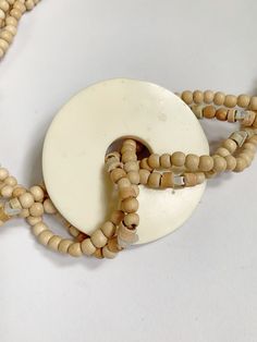 Fun vintage 1980s shell and wood necklace! Total of 4 strands of wooden and shell beads and a pastel shell inlay circle pendant center. Hook clasp with no makers mark. Overall good condition. Very minor wear23 inches end to end, pendant is 2 and 1/2 inches tall and wide. Discounts offered for bulk purchases. Shop accepts PayPal, credit cards, and Etsy gift cards. ♥Check out the rest of the shop♥ https://www.etsy.com/shop/artdecodame Wooden Beads Round Necklace For Beach, Vintage Wooden Beaded Necklaces For Beach, Vintage Wooden Beaded Necklace For Beach, Vintage Wooden Bead Necklaces For Beach, Shell Beads Necklace, Rhinestone Jewelry Set, Vintage Rhinestone Jewelry, Starburst Earrings, Wood Necklace